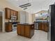 Well-equipped kitchen boasts stainless appliances, island, breakfast bar, and natural lighting at 8211 Canyon Creek Way, Tampa, FL 33647