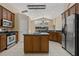 Spacious kitchen features stainless steel appliances, center island, and tile flooring at 8211 Canyon Creek Way, Tampa, FL 33647
