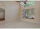 Sunny room with vaulted ceiling, ceiling fan, large windows, and tile flooring at 8211 Canyon Creek Way, Tampa, FL 33647