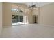 Spacious living area featuring tile floors, large windows, and access to the outdoor pool at 8211 Canyon Creek Way, Tampa, FL 33647
