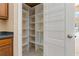 Walk-in pantry features custom shelving, abundant storage, and easy organization at 8211 Canyon Creek Way, Tampa, FL 33647
