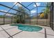 Private screened-in pool area with a unique shape and inviting blue water at 8211 Canyon Creek Way, Tampa, FL 33647