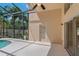 Poolside view of a covered patio and sliding glass doors to the home's interior at 8211 Canyon Creek Way, Tampa, FL 33647