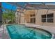 Enclosed pool featuring a unique design, offering privacy and a refreshing escape at 8211 Canyon Creek Way, Tampa, FL 33647