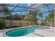 Relaxing screened-in pool, surrounded by well-maintained landscaping and mature trees at 8211 Canyon Creek Way, Tampa, FL 33647
