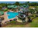 Resort-style pool area with a winding water slide, lounge chairs, mature palm trees, and well-maintained landscaping at 8211 Canyon Creek Way, Tampa, FL 33647
