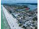 Beautiful aerial shot of the coastline with beach, condos, and a waterfront community with bay access indicated by red arrow at 829 E Gulf Blvd # 107, Indian Rocks Beach, FL 33785