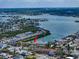Scenic aerial view of waterfront townhomes community with boat docks and bay access indicated by red arrow at 829 E Gulf Blvd # 107, Indian Rocks Beach, FL 33785