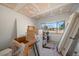 Bright bedroom featuring a window with neighborhood views and supplies for remodeling the ceiling and walls at 829 E Gulf Blvd # 107, Indian Rocks Beach, FL 33785