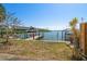 Waterfront condo featuring a private boat dock and lush tropical landscaping at 829 E Gulf Blvd # 107, Indian Rocks Beach, FL 33785