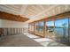 Living room being renovated featuring large windows and waterfront views at 829 E Gulf Blvd # 107, Indian Rocks Beach, FL 33785