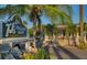Exterior view of TJ's Italian Cafe surrounded by palm trees, featuring a charming porch and visible signage at 829 E Gulf Blvd # 107, Indian Rocks Beach, FL 33785