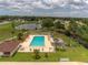 Aerial view of community pool, lake, and residential area at 9922 86Th Way, Seminole, FL 33777