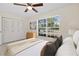 Bright bedroom with a view of the neighborhood outside, featuring generous closet space and contemporary decor at 9922 86Th Way, Seminole, FL 33777