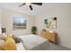 Comfortable bedroom with a large window, minimalist furniture, and decor providing a peaceful atmosphere at 9922 86Th Way, Seminole, FL 33777