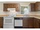 Well-lit kitchen offers classic cabinetry, essential appliances, and a functional layout at 9922 86Th Way, Seminole, FL 33777