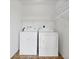 Practical laundry room with washer, dryer, and overhead wire shelving at 9922 86Th Way, Seminole, FL 33777