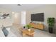 Bright living room with sleek TV and stylish furniture, creating a cozy atmosphere at 9922 86Th Way, Seminole, FL 33777