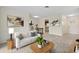 Inviting living room featuring neutral tones, stylish decor, and an open floor plan with an adjacent dining area at 9922 86Th Way, Seminole, FL 33777