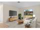 Comfortable living room with neutral carpet, slider to the backyard, a television, and modern decor at 9922 86Th Way, Seminole, FL 33777