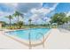 Outdoor swimming pool with blue water surrounded by lounge chairs and palm trees at 9922 86Th Way, Seminole, FL 33777