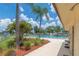 Outdoor pool with palm trees and lounge chairs under a blue sky at 9922 86Th Way, Seminole, FL 33777