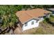 Aerial view of a single story home with a brown roof surrounded by mature trees and minimal landscaping at 111 Orangeview Ave, Clearwater, FL 33755