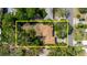 Aerial view highlighting the property's roof and surrounding mature trees at 111 Orangeview Ave, Clearwater, FL 33755