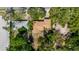 Aerial view of property with mature trees and lush landscaping, offering privacy and shade at 111 Orangeview Ave, Clearwater, FL 33755