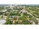 Expansive aerial view of a neighborhood with mature trees, showcasing community layout and proximity to city amenities at 111 Orangeview Ave, Clearwater, FL 33755