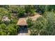 Aerial view of a home with a carport surrounded by mature trees at 111 Orangeview Ave, Clearwater, FL 33755