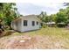 Backyard view of a white house surrounded by trees at 111 Orangeview Ave, Clearwater, FL 33755