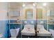 Retro bathroom with blue tiles, double sinks, and vintage fixtures at 111 Orangeview Ave, Clearwater, FL 33755