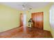Bedroom featuring hardwood floors, closet, and a view into another room at 111 Orangeview Ave, Clearwater, FL 33755