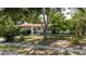 Charming single-story home featuring a covered parking spot and mature landscaping at 111 Orangeview Ave, Clearwater, FL 33755