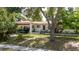 Single-story home with a covered parking spot and mature trees at 111 Orangeview Ave, Clearwater, FL 33755