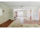 Spacious living room featuring a front window, hardwood floors and vintage carpet at 111 Orangeview Ave, Clearwater, FL 33755