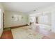 Bright living room with vintage touches including a mirror, wall sconces and carpeting at 111 Orangeview Ave, Clearwater, FL 33755