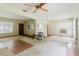 Open-plan living room with vintage charm, including a ceiling fan and front windows at 111 Orangeview Ave, Clearwater, FL 33755