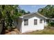 Side view of a white painted single story home showing several windows and minimal landscaping at 111 Orangeview Ave, Clearwater, FL 33755