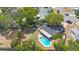 Birds eye view of a backyard with a fenced-in pool, surrounded by mature trees and a small storage shed at 1159 19Th Sw Ave, Largo, FL 33778