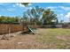 Spacious backyard with wooden playset, a shed and a well-maintained lawn, perfect for outdoor activities at 1159 19Th Sw Ave, Largo, FL 33778