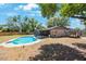 Backyard offers a sparkling pool, a covered patio, and ample green space at 1159 19Th Sw Ave, Largo, FL 33778