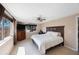 Spacious bedroom with a ceiling fan, large windows, a wood headboard, and tiled flooring at 1159 19Th Sw Ave, Largo, FL 33778