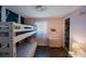 Cozy bedroom featuring a charming bunk bed, accent wall, and walk-in closet at 1159 19Th Sw Ave, Largo, FL 33778