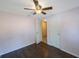 Clean bedroom showcasing two doors, one with entry to another room, and a ceiling fan at 1159 19Th Sw Ave, Largo, FL 33778