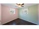 Neat bedroom with two windows letting in natural light and white molding along the baseboards at 1159 19Th Sw Ave, Largo, FL 33778