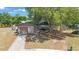 Charming single-story home with attached garage, paved driveway, and mature landscaping at 1159 19Th Sw Ave, Largo, FL 33778