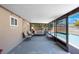 Screened lanai boasts a sitting area with a view of the pool and tropical foliage at 1159 19Th Sw Ave, Largo, FL 33778