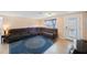 Spacious living room featuring tile flooring, a large sectional sofa, and ample natural light at 1159 19Th Sw Ave, Largo, FL 33778